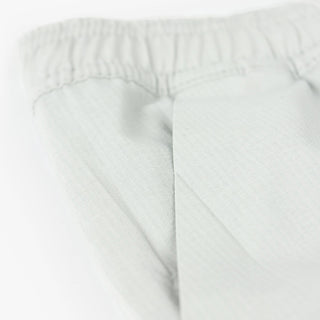 detail view of the side pocket and fabric of the ciele athletics WRKShort unisex running and technical short from the Lifestyle Edition collection, in light grey color