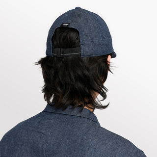 back view of ciele athletics CRWCap short brim unisex running hat with shorter brim from the Lifestyle Edition collection, in denim indigo color, on a model